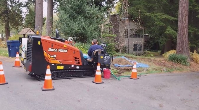 Ditch Witch directional drilling machine boring underground water line without trenching yard